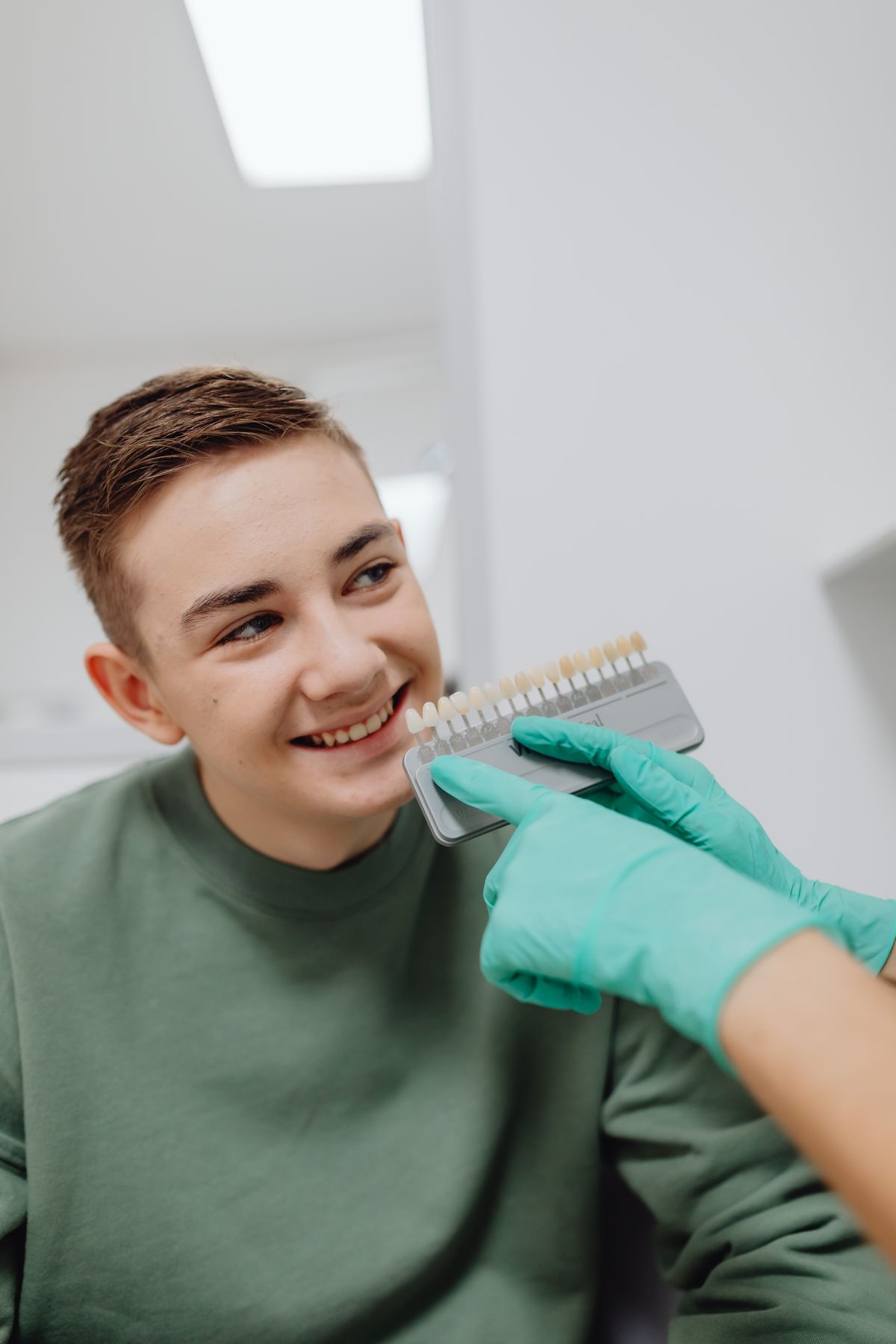 A smiling dental patient during a shade-match check
